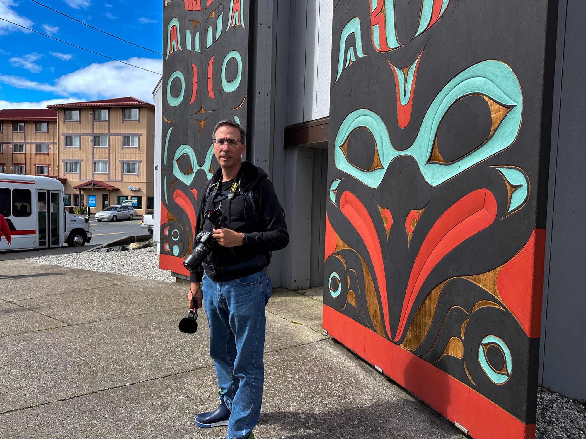 Photo of Ted in front of Tlingit tribal house, Sitka.