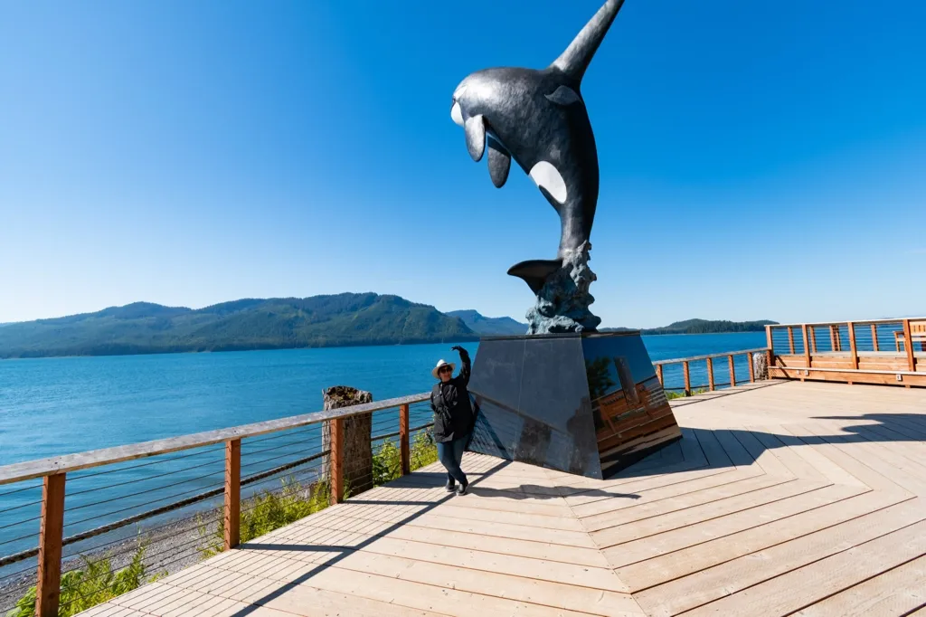 Photo of Galina posing with killer whale sculpture