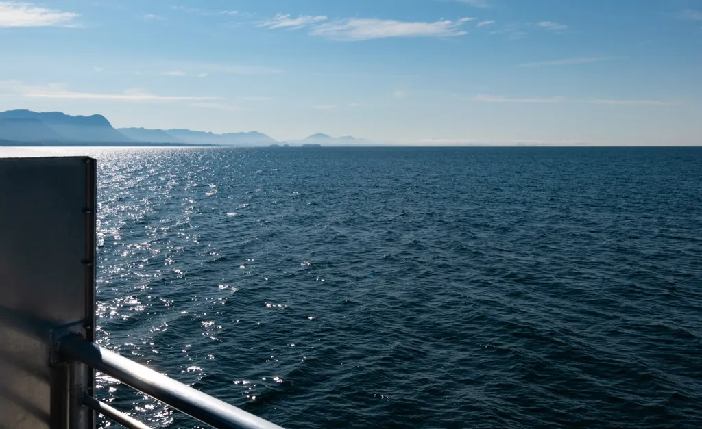 Photo of View from port side looking aft. Islands and mountains.